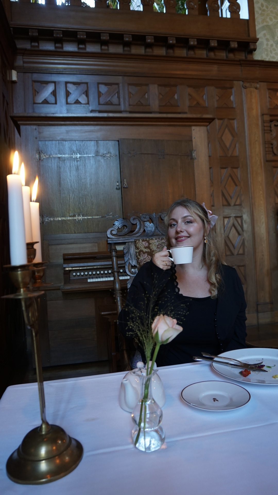 Tea by candlelight in a dark wood panelled room